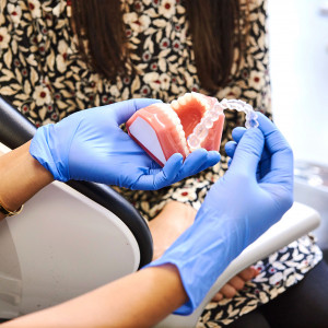 dentist showing patient invisalign aligner